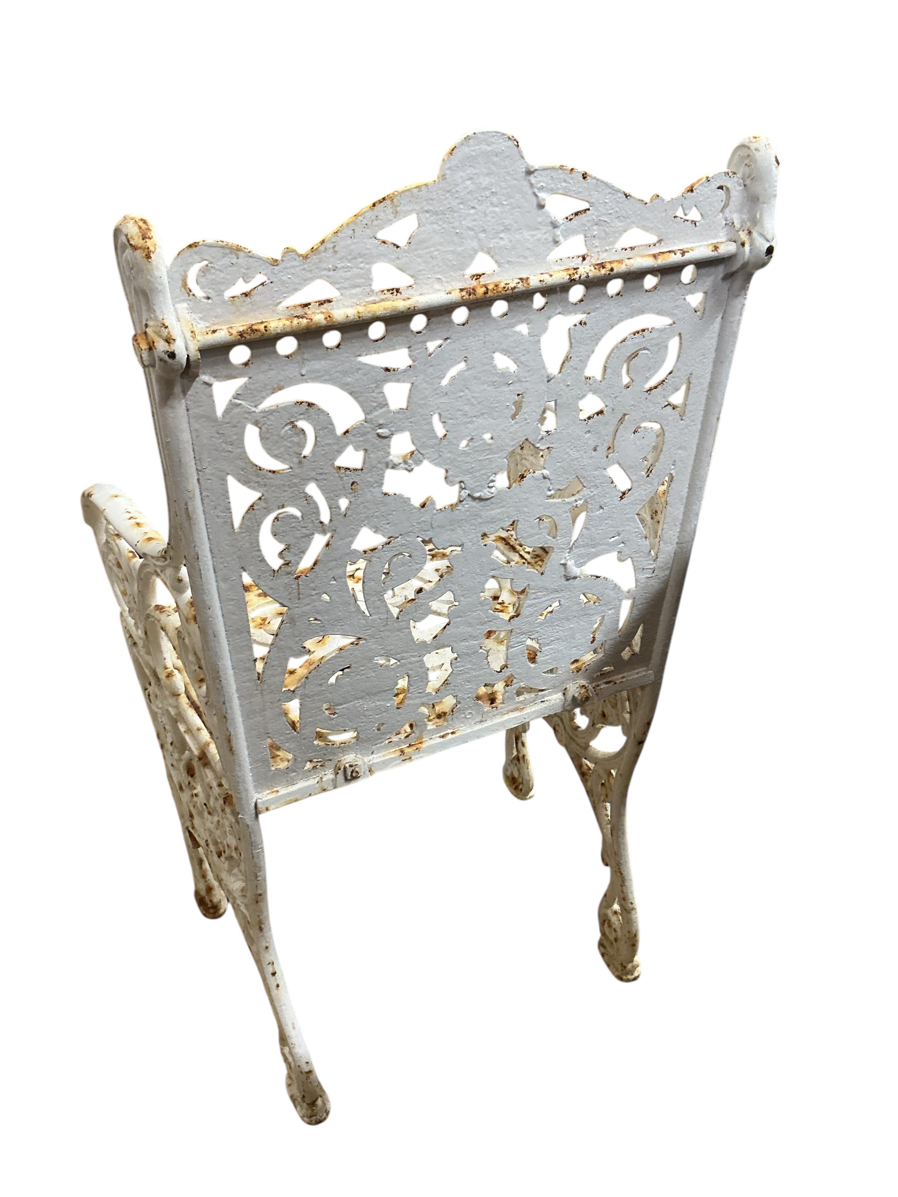 A Victorian Coalbrookdale style painted cast iron garden elbow chair, width 46cm, depth 38cm, height 88cm